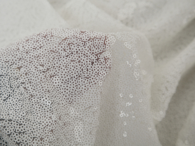 Fine white sequins fabric on tulle
