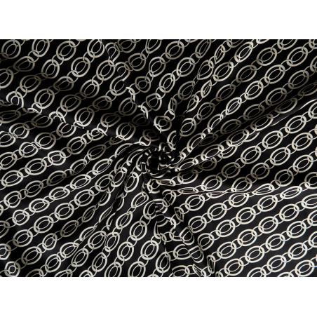 Viscose fabric with a delicate sheen — chain-like pattern on a black background