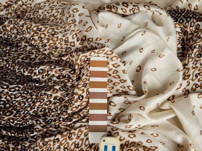 Viscose fabric with a delicate sheen, cream-colored with a leopard print - report