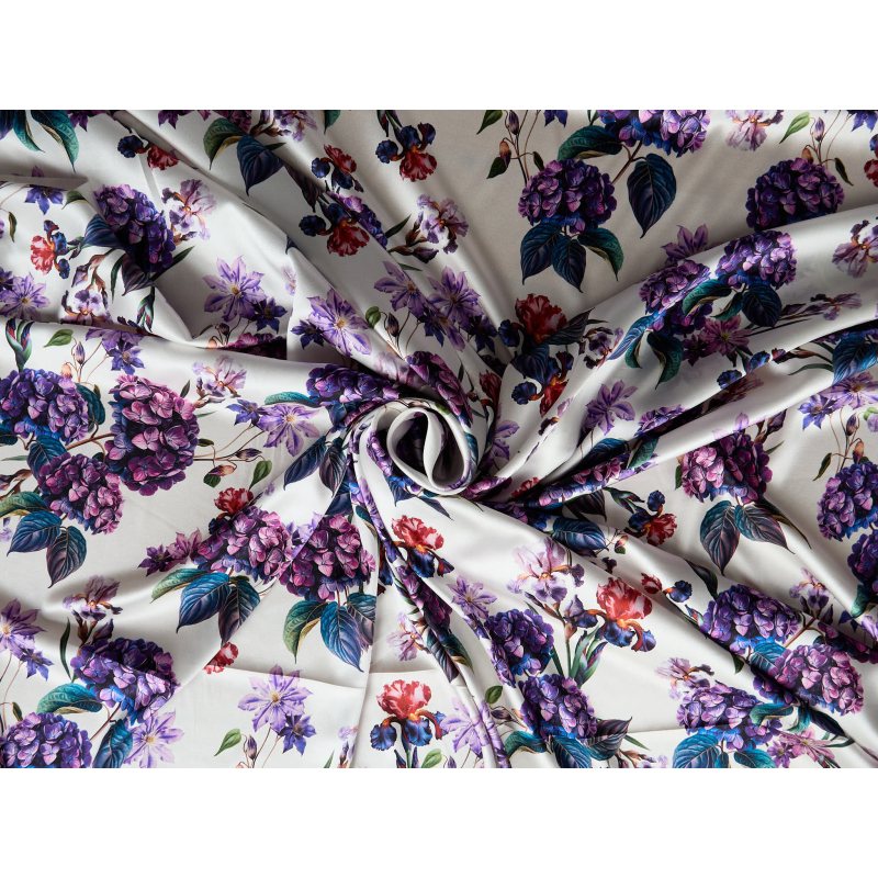Silk satin with elastane in a floral violet pattern on a cream background