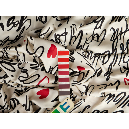Viscose fabric with a delicate sheen and black lettering